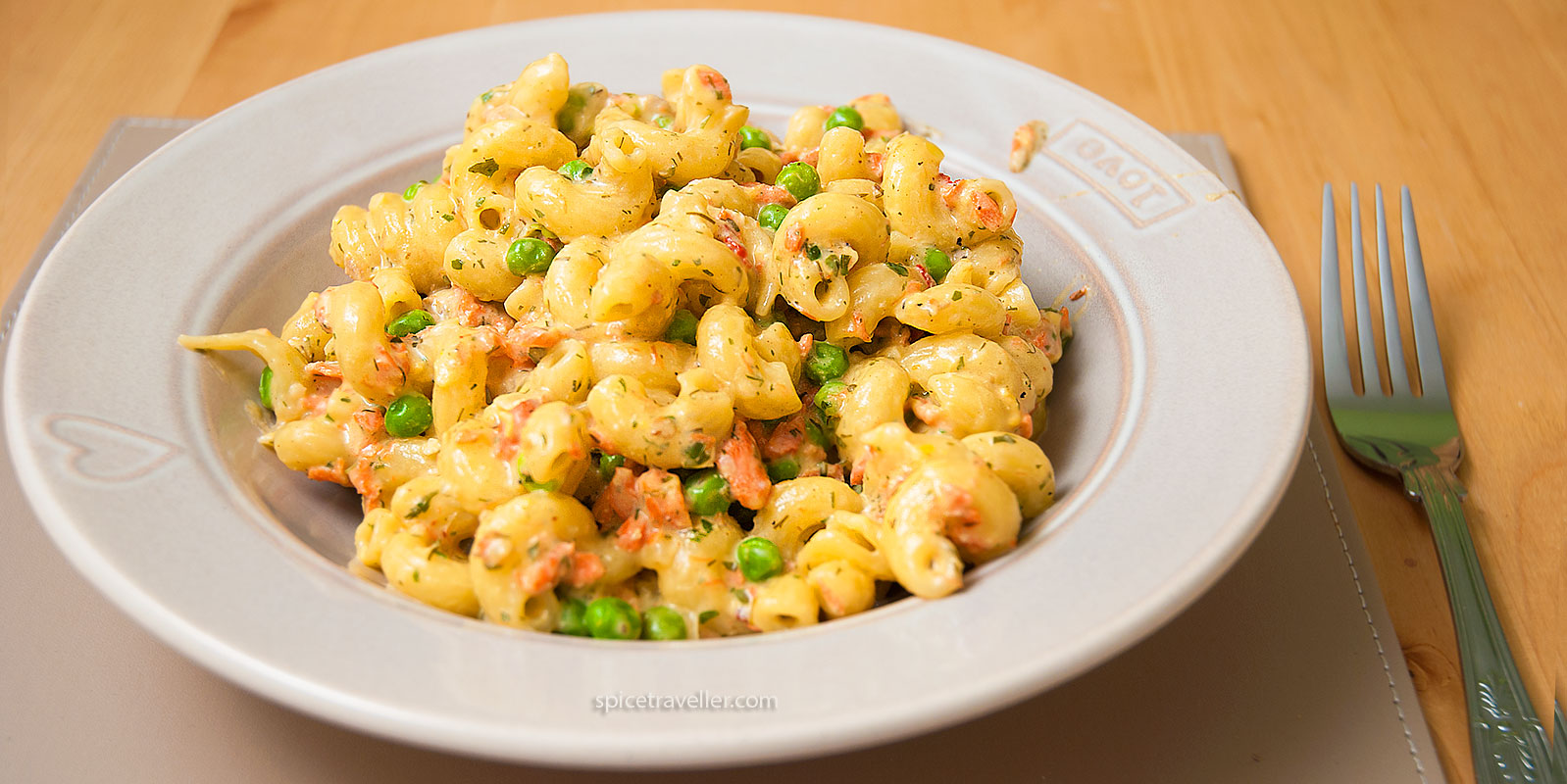 Bowl of pasta with creamy salmon and peas sauce