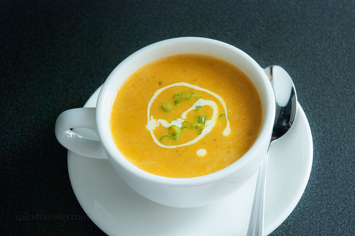 Carrot and coriander soup topped with cream and chives