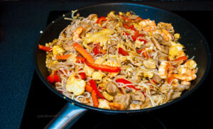 Chicken and Prawn Lo Mein dish served in a bowl with a colorful array of vegetables, noodles, and a savory sauce.