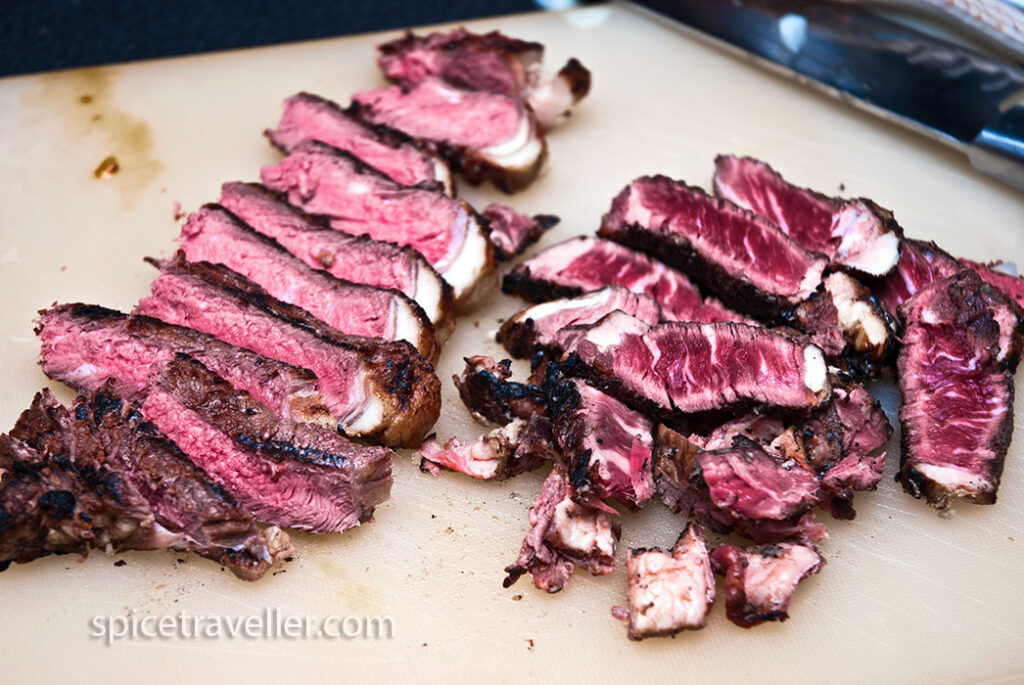 Sliced rare roasted beef, ready to be added to the goulash for enhanced flavor and richness."