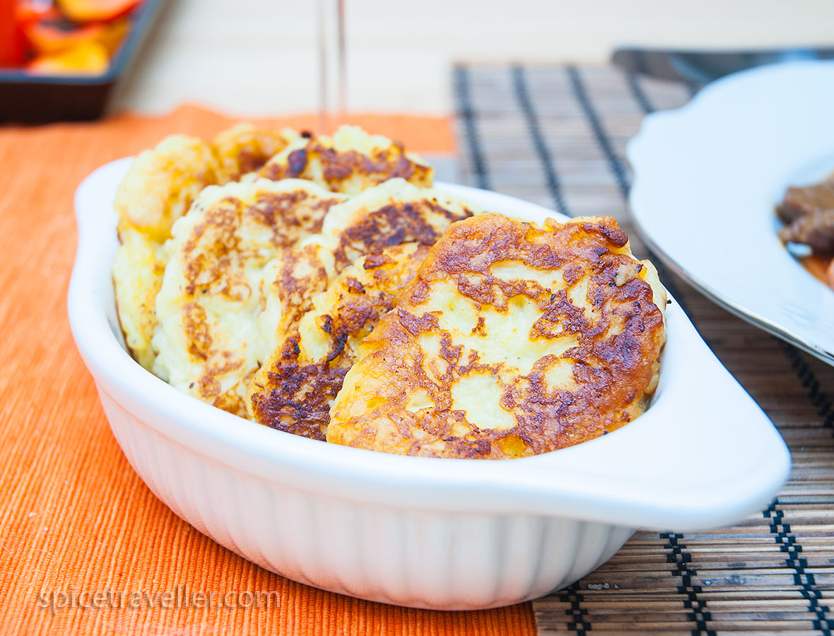 Irresistible Irish Potato Bread Cakes, neatly arranged in a small dish, showcasing their golden brown exterior and inviting texture