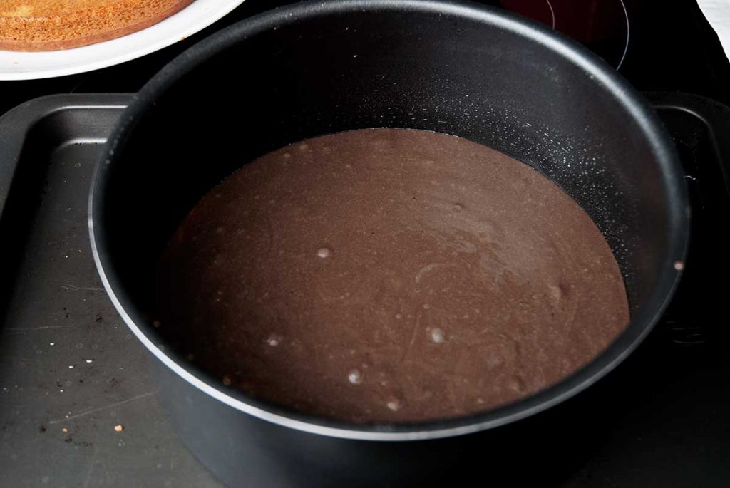 Chocolate batter in a cake tin, ready to bake.