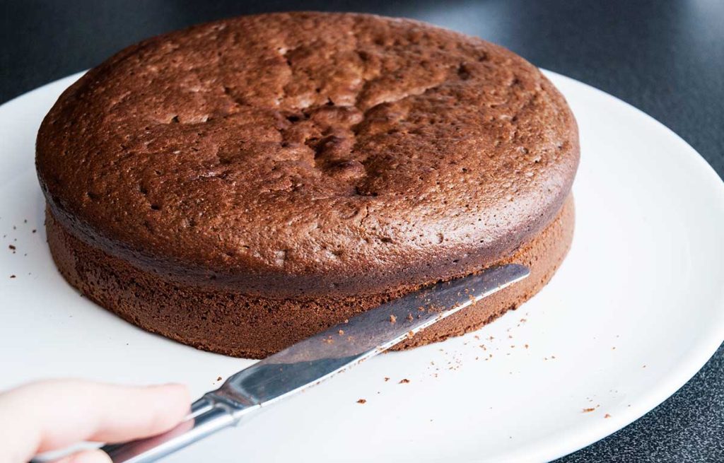 Shallow cutting around the edge of the walnut cake layer using a small kinfe to make marking.