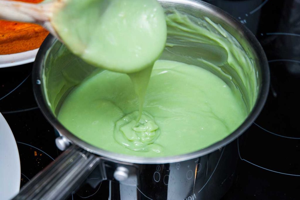 Making green cream for the Halloween cake.