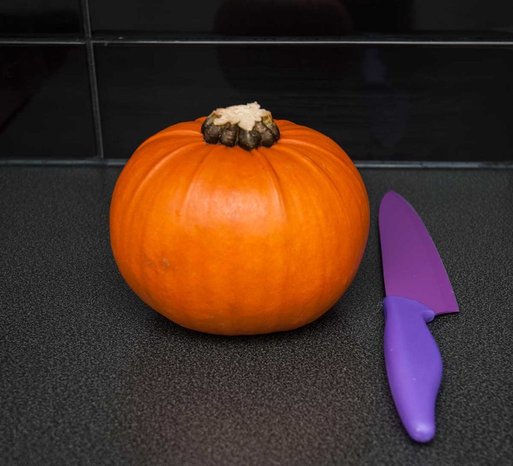 Mini pumpkin ready to cut and prepare for baking.