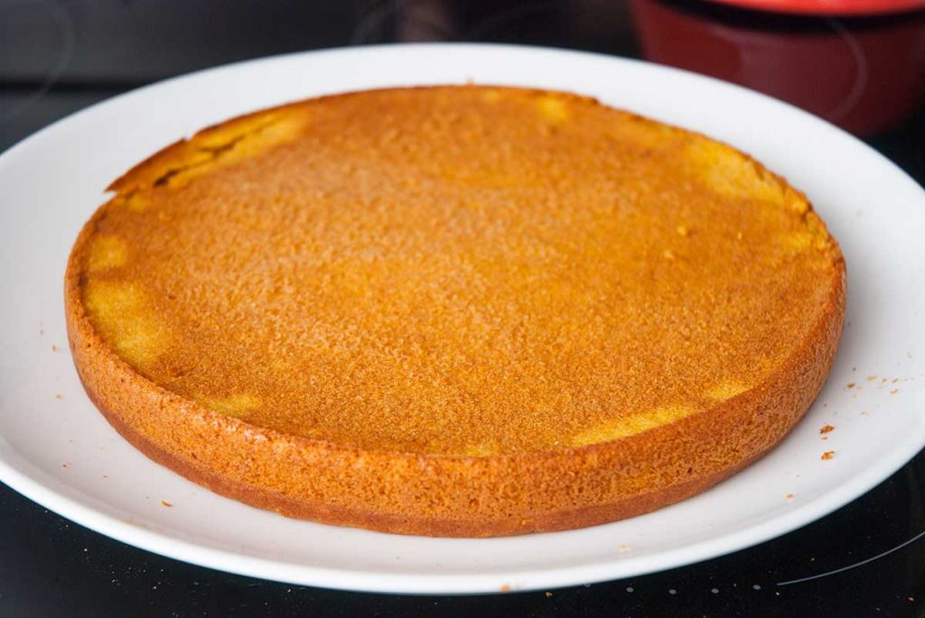 Pumpkin sponge cake layer turned over on a plate. 