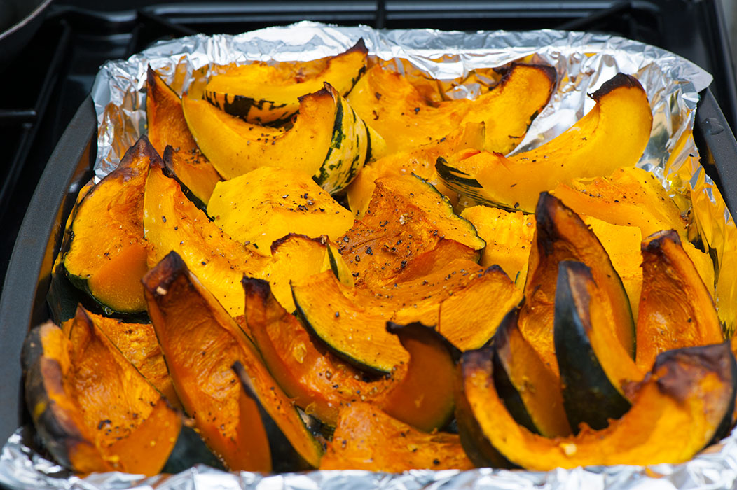 Roasted pumpkin on a tray, ready for Halloween pumpkin risotto