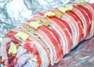 deboned whole turkey roulade decorated with bacon rashers