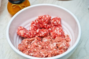 turkey roulade stuffing preparation - pork mince and sausage meat in a bowl