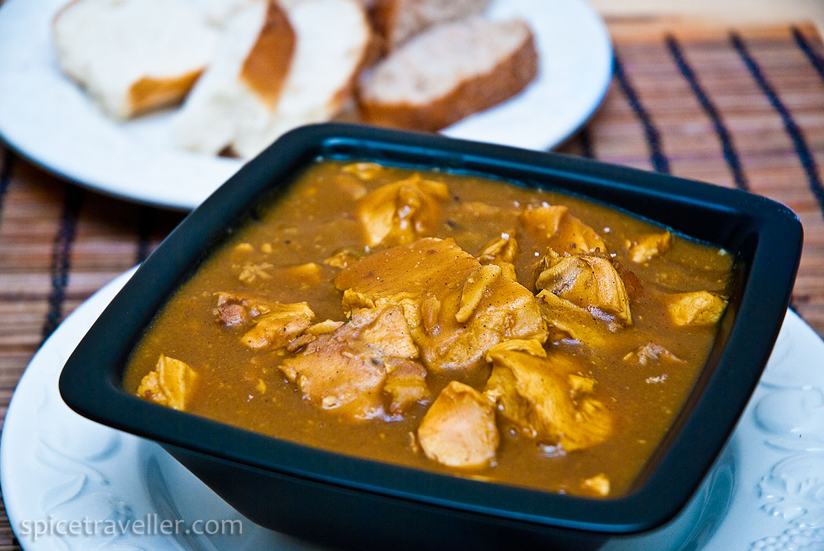 Whole turkey roulade leftovers curry in a bowl served with bread