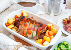 Christmas lamb roast with stuffing served with roasted vegetables