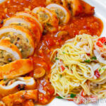 Delicious large stuffed sliced squid in rich tomato sauce Mediterranean style, served with pasta