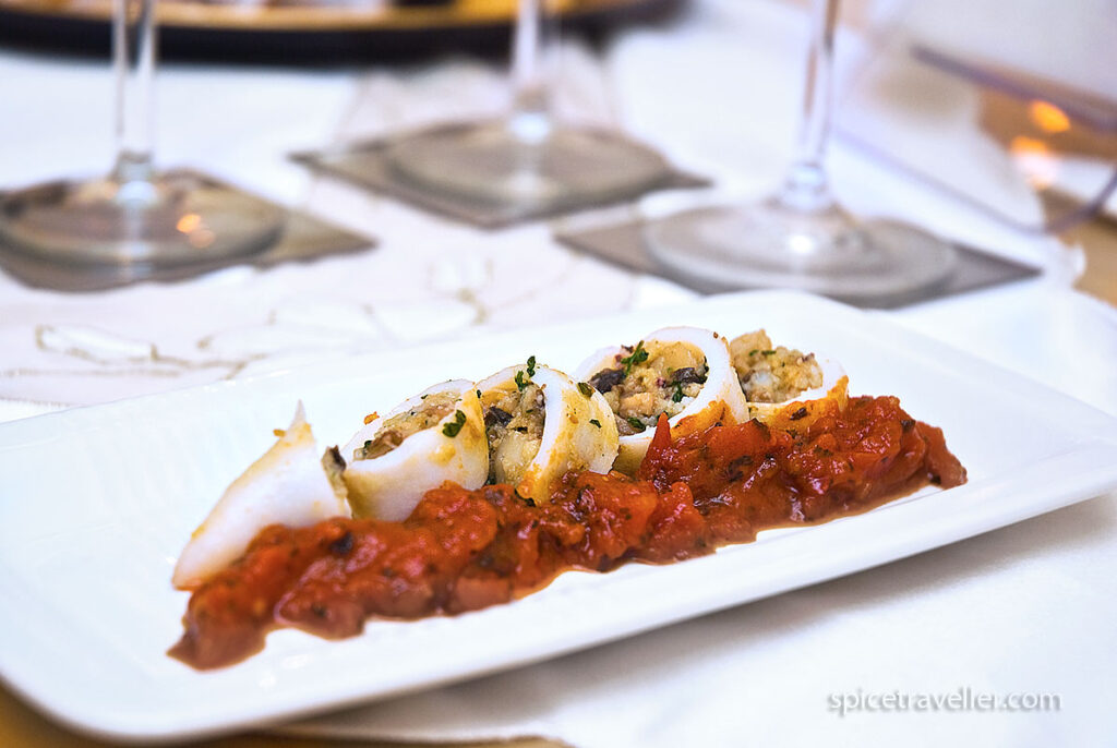 Mediterranean stuffed squid served as a starter with tomato sauce topping