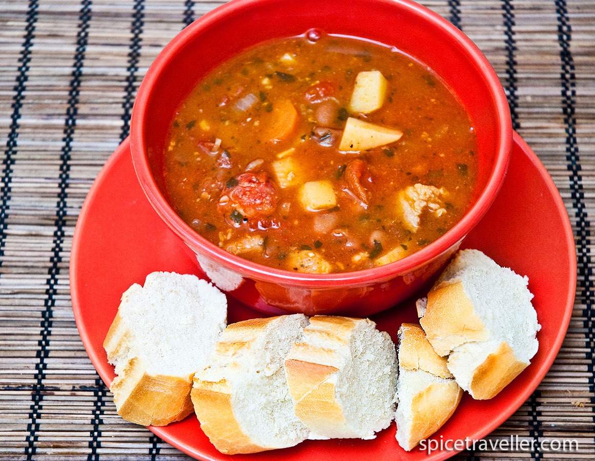Spanish Bean and Chorizo Sausage Soup ( Fabada ) served with homemade bread slices.