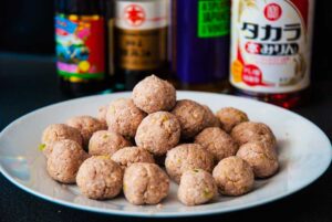 Perfectly shaped small chicken meatballs ready to fry and prepare for sweet and sour sauce