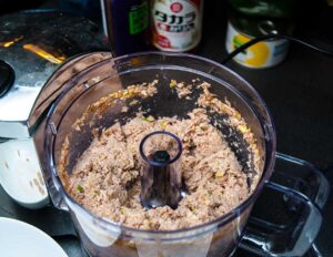 Blended chicken meat in a blender ready to prepare meatballs