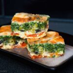 Three squared pieces of vegetable crust-free quiche