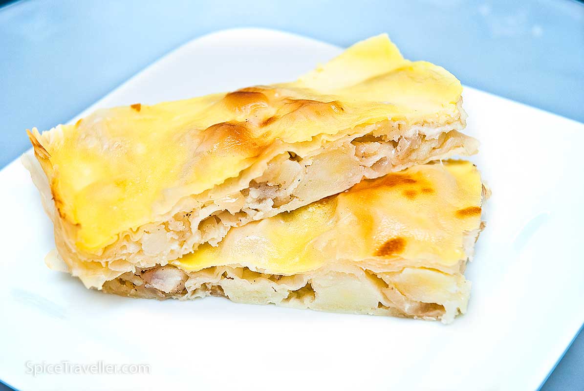 Two squared slices of potato and onion savoury pastry - Turkish borek