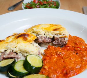 Albanian peppers and tomatoes bake ( fergese) served with meat. 