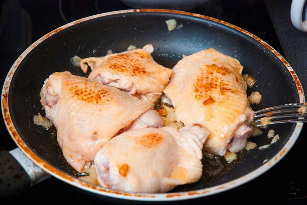 Browned chicken thighs ready to prepare Hungarian chicken paprikash. 