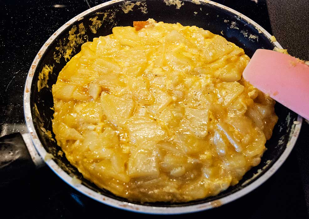 Making Spanish tortilla potato omelette in a pan