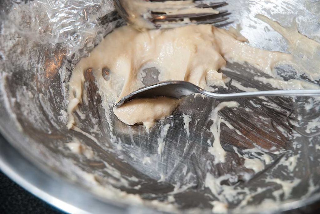 Making Hungarian dumplings - close up of how to scoop dough with a teaspoon 