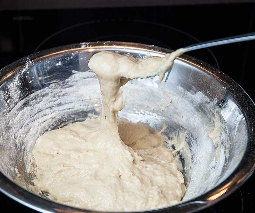 Preparing Hungarian dumplings, showing dough stretchy texture.