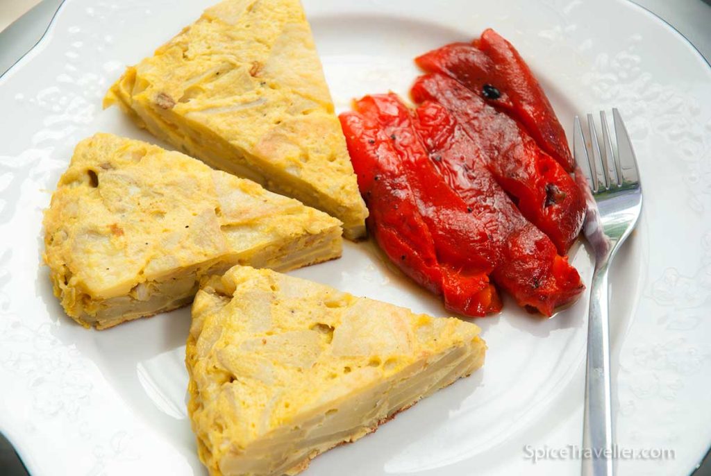 Three pieces of Spanish tortilla or potato omelette served with red roasted peppers.