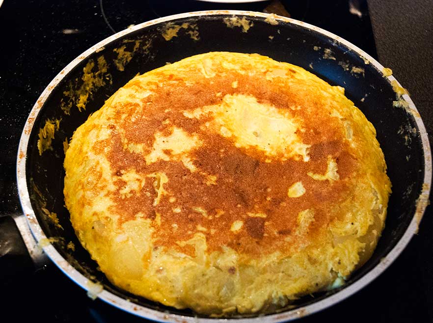 Spanish tortilla potato omelette in a pan once flipped.