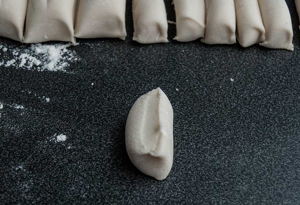 One piece of cut dough positioned on its side.