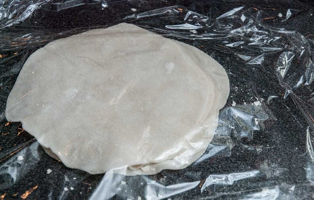 Rolled dough pieces covered with cling film ( plastic wrap) 