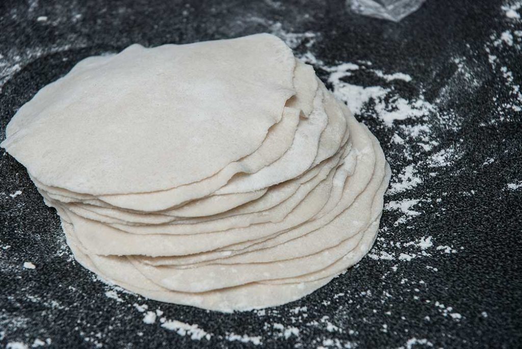 Stack of all dough pieces properly rolled and waiting to be filled.