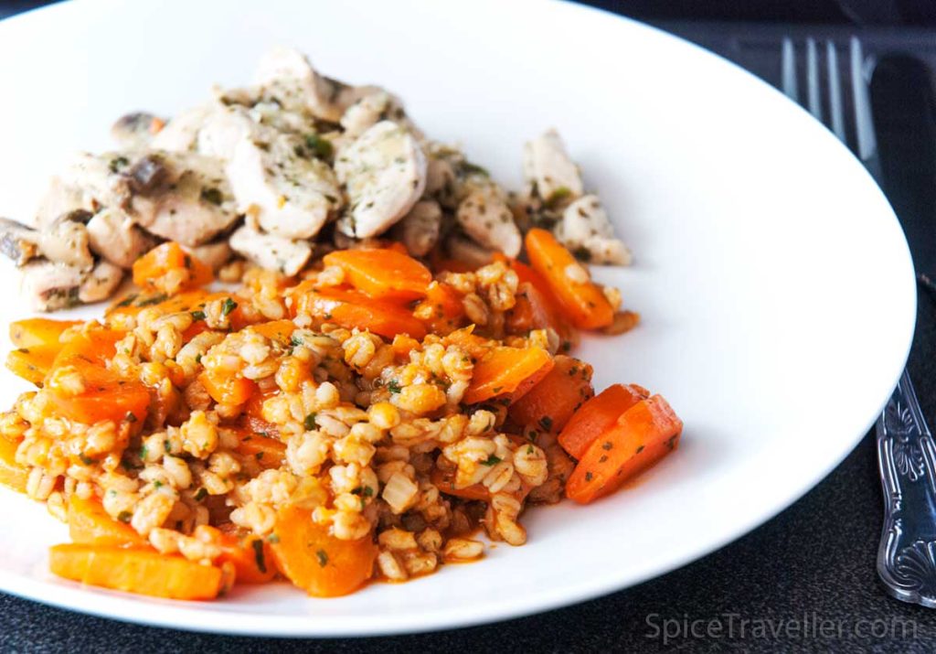 Carrot and barley side dish served with chicken breast and mushrooms.