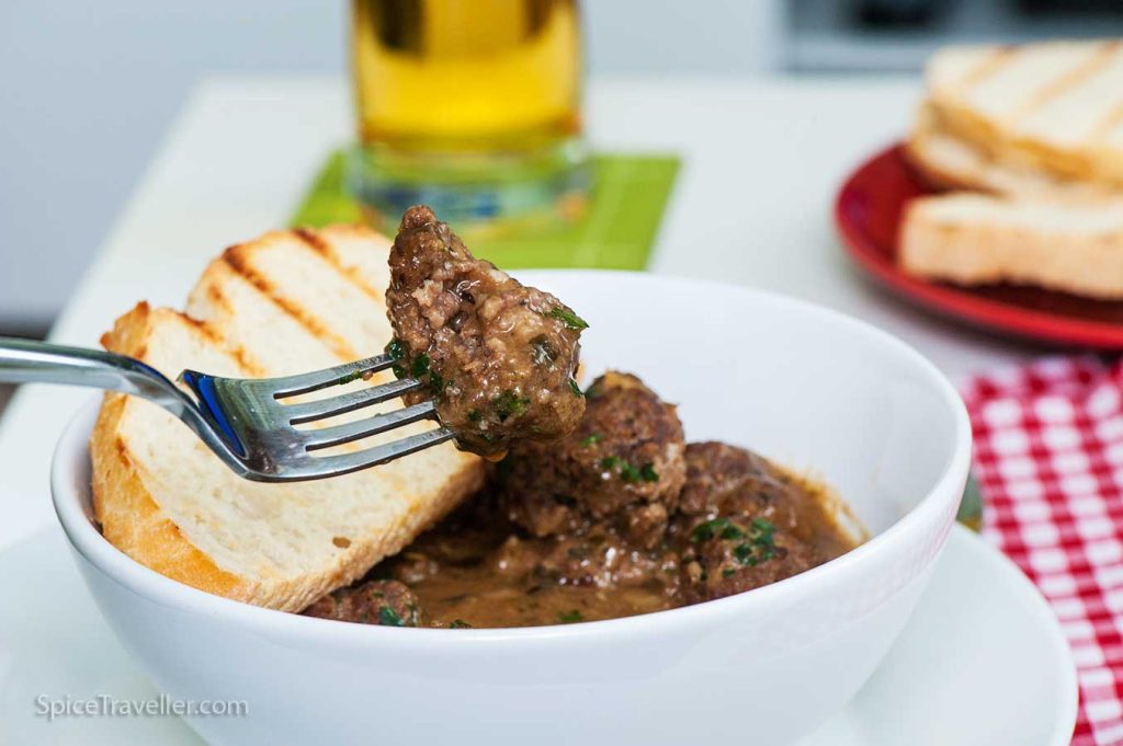 Close up of delicious Bealgian beef stew meatball on a fork.