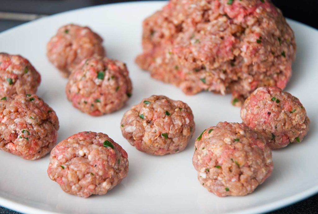 Making beef meatballs.