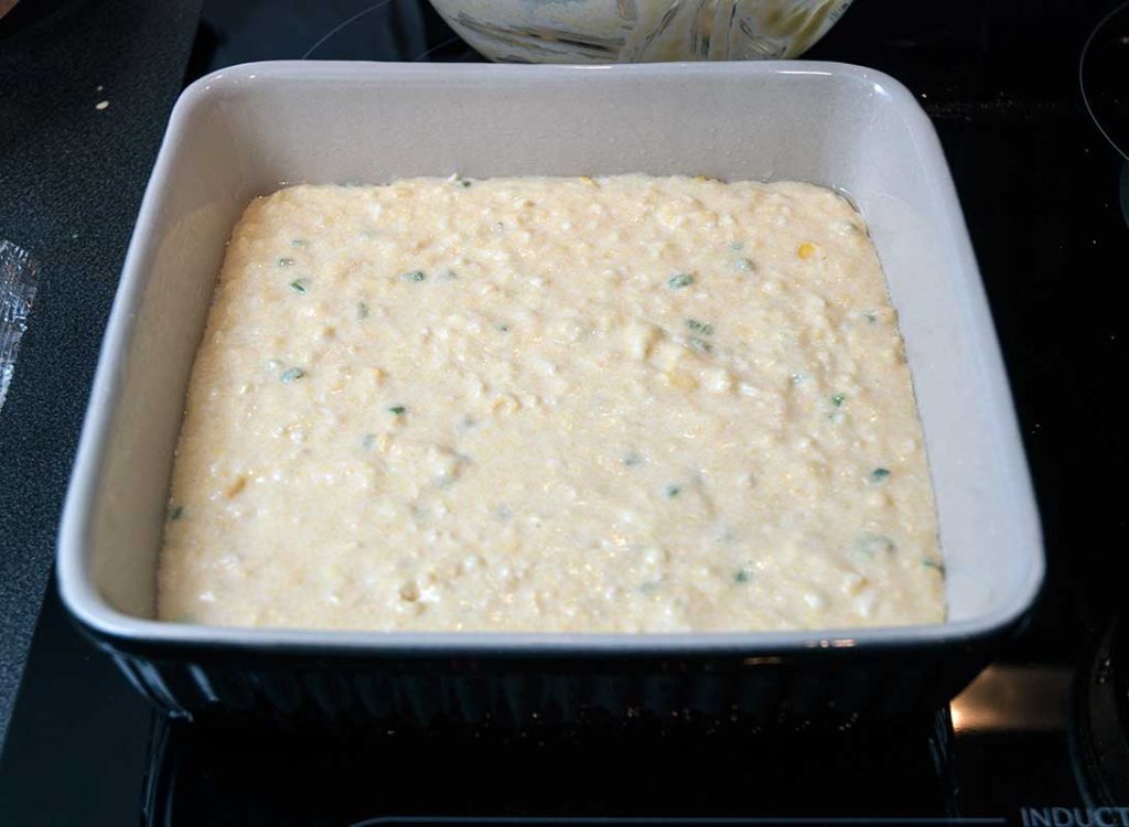 Texas corn bread mixture in a baking tray ready to bake.