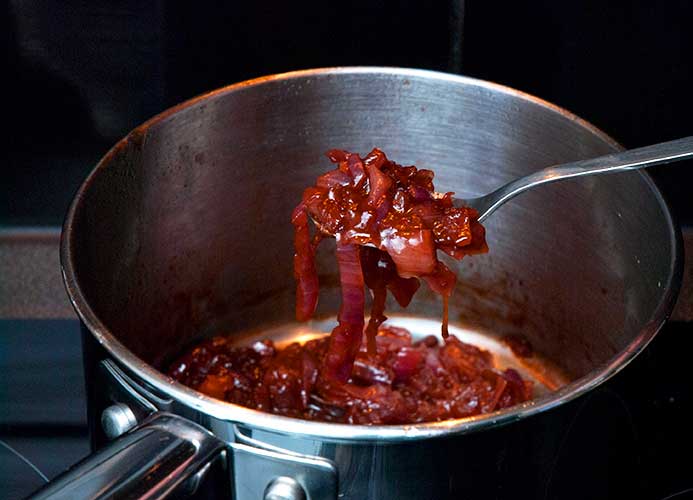 A metal pot with delicious and syrupy caramelised onion cooked in beer, a must topping for Australian snags!