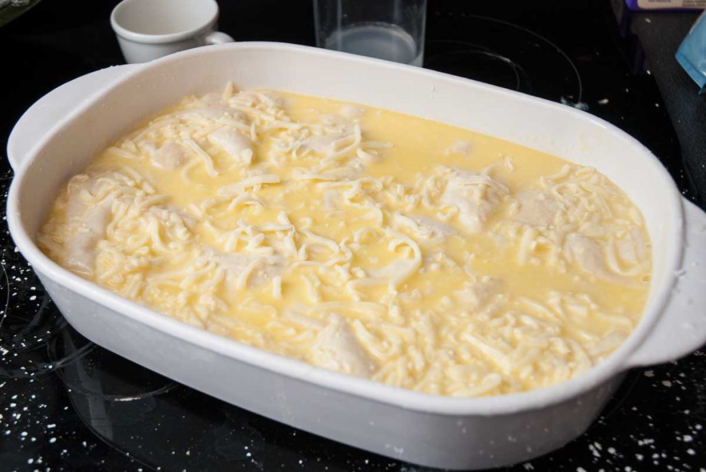 Banitsa ( cheese and yoghurt pie) topped with cheese mixture before baking.