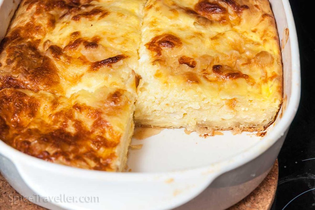 Perfectly baked Banitsa with a golden, crisp top and part of the tray empty, showing the layers of delicious filling inside.