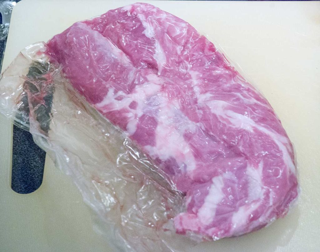 Chunk of fresh lamb meat on a cutting board.