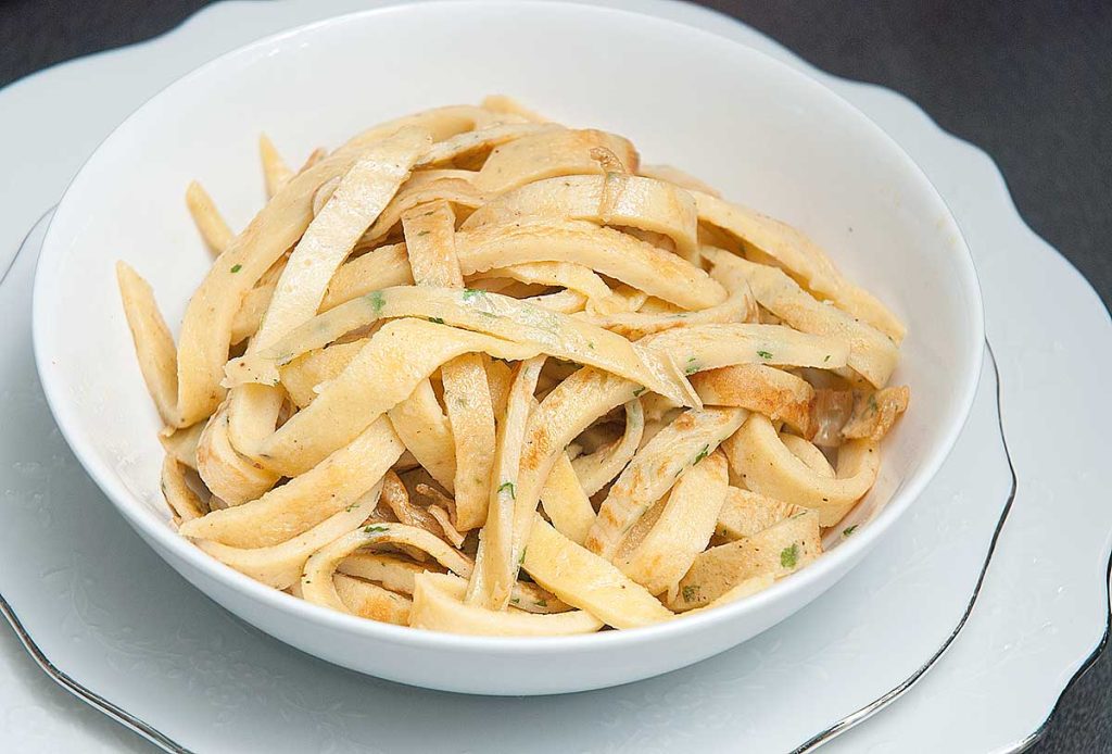 Bowl full of pancake  strips, ready to serve with Tafelspitz broth. 