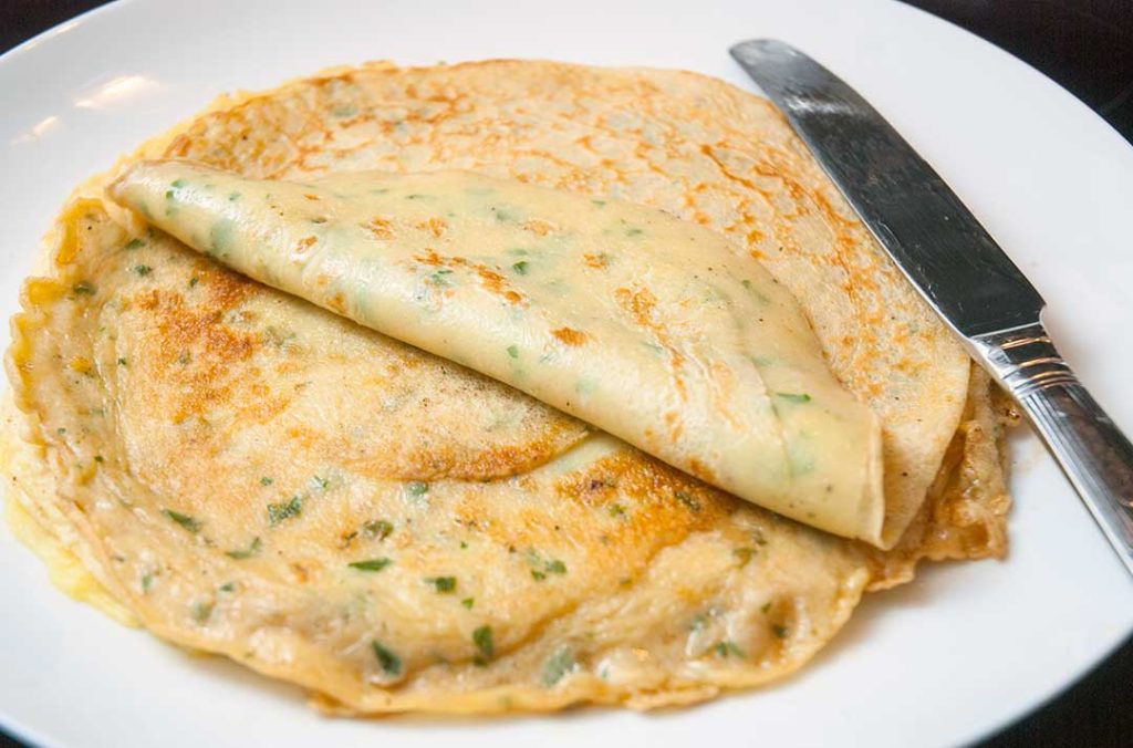 Closeup of pancakes with chives showing a perfect texture.