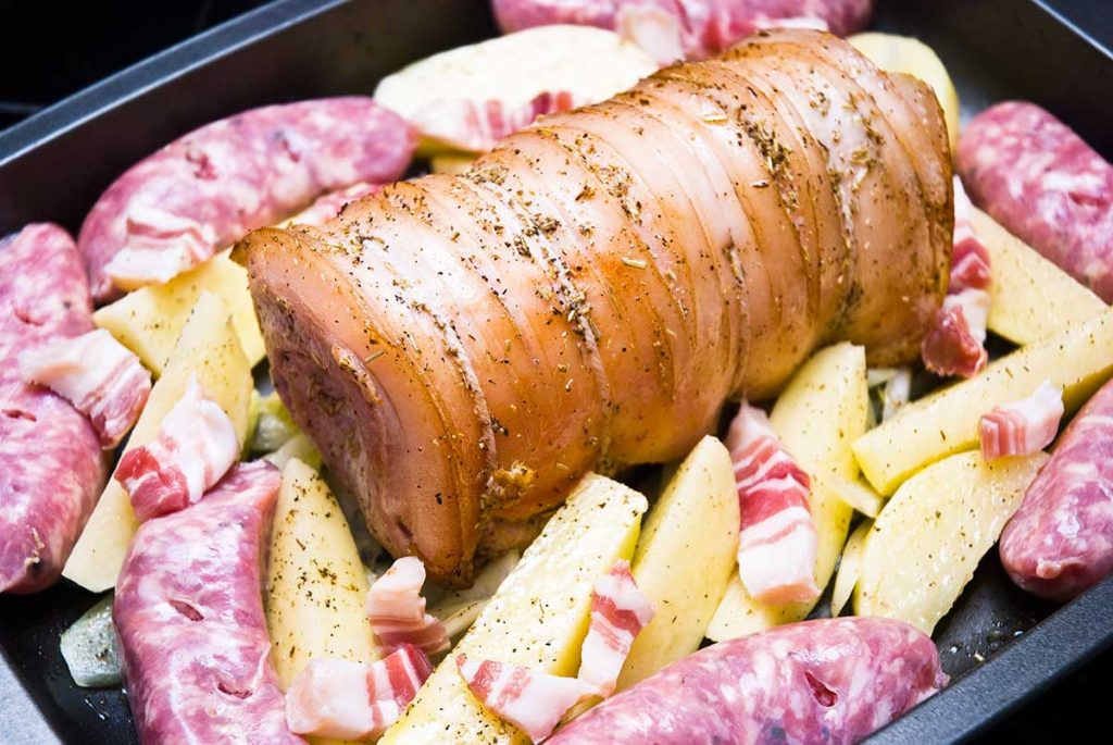 Pork loin and potato with pork & herb sausages, ready to roast.