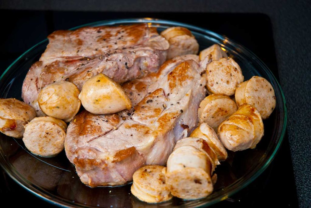 Fried sausages and pork steaks.