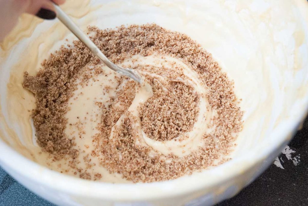 Mixing ground walnut with batter.