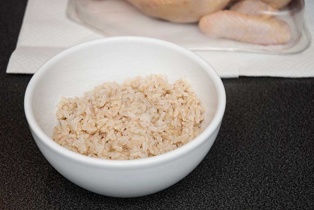 A white bowl with plain cooked rice.