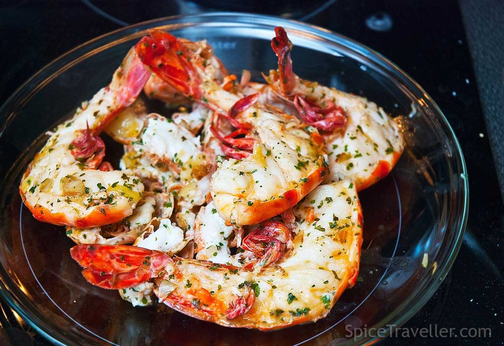 Seared langoustine and pking prawn tails resting a plate.