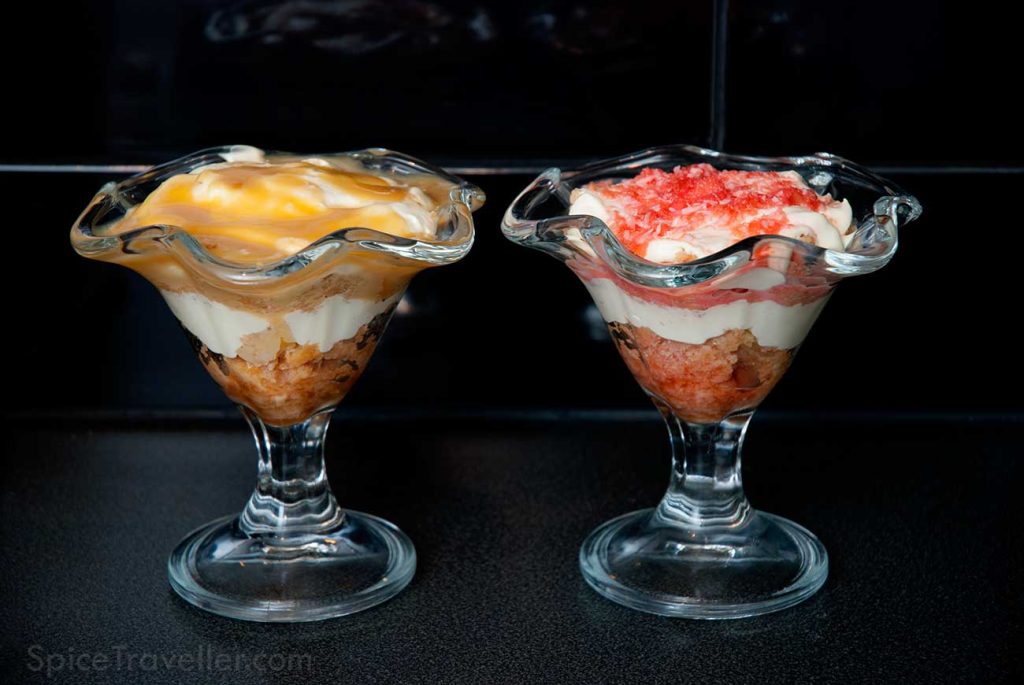 What to do with sponge cake and glazing leftovers - Two dessert glasses with sponge cake leftovers soaked in drizzle sauce and layered with whipped cream and topped with glazing sauce.