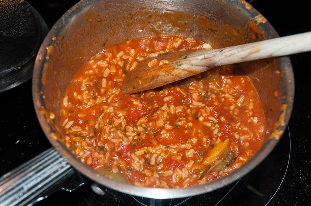 Cooked rice mixed with tomato and pepper sauce.