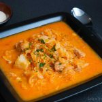 Black rectangular bowl with delicious hungarian sauerkraut and pork stew.